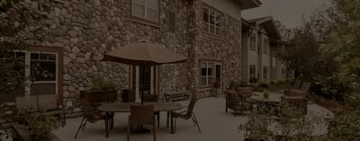 Outdoor seating area with stone wall and patio furniture