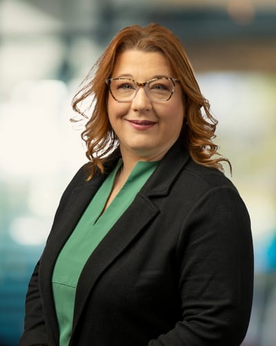 Professional portrait of a woman in a green blouse