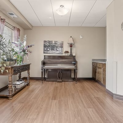 A common area with a piano and wooden decor