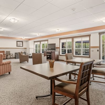 Bright common area with seating and large windows