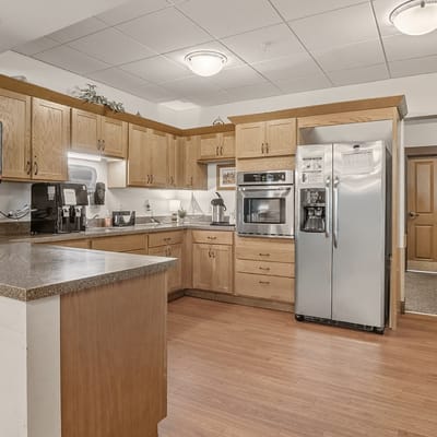 Bright kitchen area with appliances and cabinetry