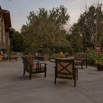 Outdoor seating area with chairs and greenery