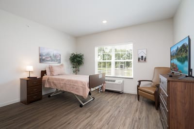 A comfortable private resident room with natural light