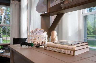 Bright interior showcasing books and gardening tools