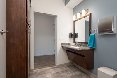 Modern bathroom with stylish fixtures and teal accents