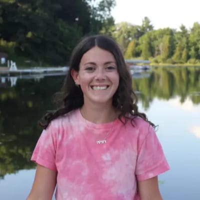 Young woman smiling by the water