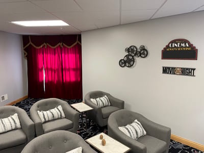 Interior lounge area with gray seating and movie night decor