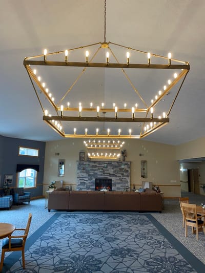 Straits Area Senior Living Community, assisted living in St. Ignace, MI — Elegant chandelier lighting in a spacious facility common area