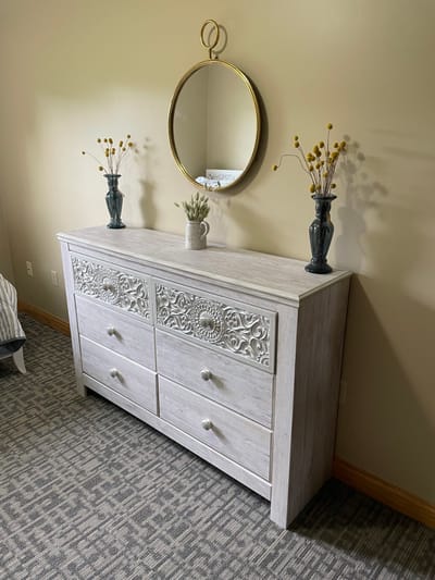 Straits Area Senior Living Community, assisted living in St. Ignace, MI — Decorative sideboard with a mirror and vases