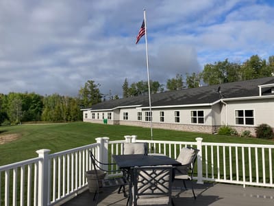 Straits Area Senior Living Community, assisted living in St. Ignace, MI — View of outdoor seating area with American flag