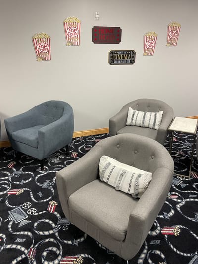 Straits Area Senior Living Community, assisted living in St. Ignace, MI — Cozy seating area with movie-themed decorations