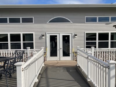Straits Area Senior Living Community, assisted living in St. Ignace, MI — Entrance to a senior living facility with outdoor seating