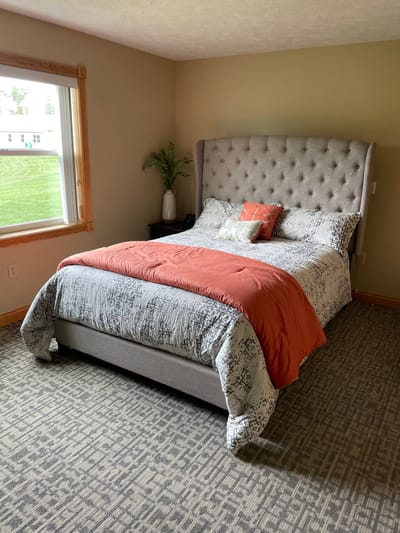 Straits Area Senior Living Community, assisted living in St. Ignace, MI — Cozy bedroom with a modern bed and decor