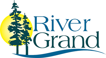 Logo of River Grand Senior Living with trees and sun