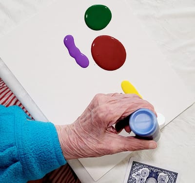 A resident painting with colorful acrylics