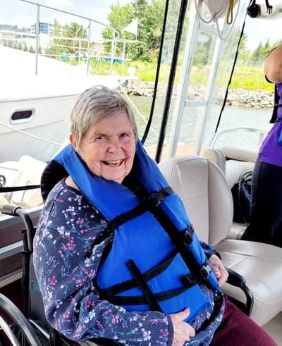 Resident enjoying a boat ride in a life jacket
