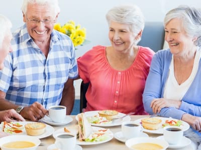 Residents enjoying a meal together in the dining room