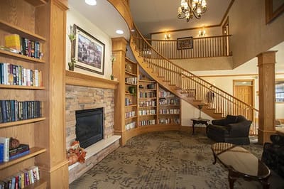Interior view of a cozy library area with stairs