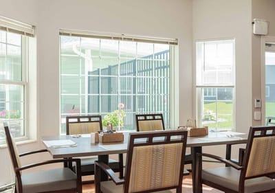 Bright dining area with large windows and tables