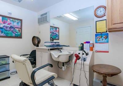 Hair salon area with wall decoration and equipment visible