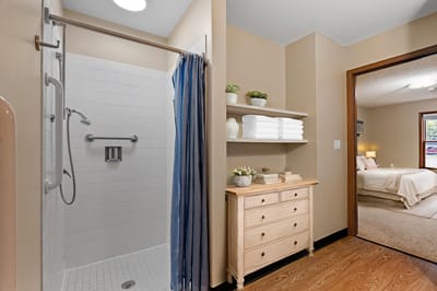 Private bathroom with shower and shelves