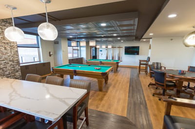 Interior view of a recreational area with billiard tables