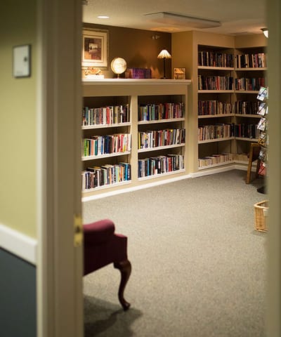 Cozy library with bookshelves and seating area