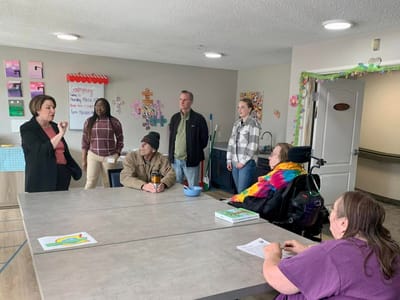 Residents and staff engaging in conversation in a common area