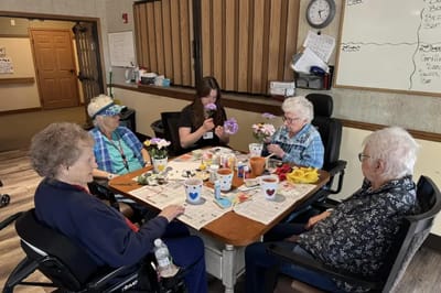 Residents participating in a flower arranging activity