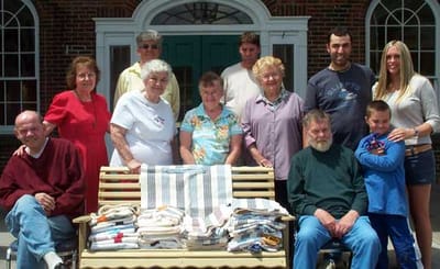 Group photo of residents and staff outside the facility