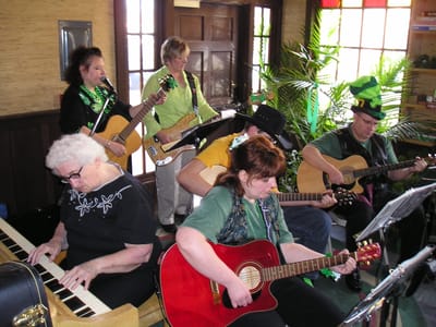Residents and staff enjoying a music activity indoors