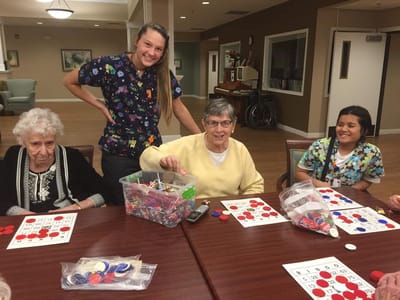 Residents playing bingo with staff engagement