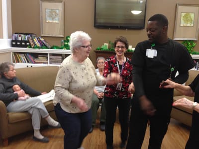 Residents and staff engaged in an activity in the common area