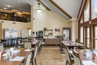 Dining room setup with tables and chairs