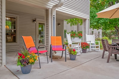 Outdoor seating area with colorful chairs and flowers