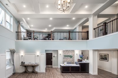 Interior view of a bright common area in a senior living facility.