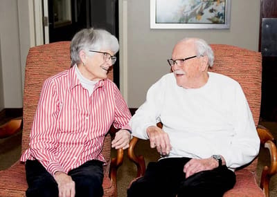 Two residents enjoying conversation in a cozy sitting area