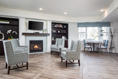 Common area with chairs and a fireplace