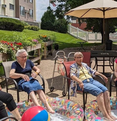 Residents enjoying time in the garden with a beach ball