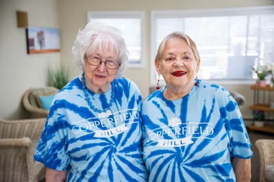 Two residents smiling in a common area