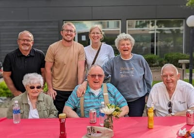 Residents and staff celebrating outdoors.