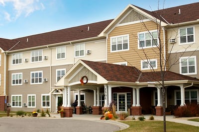 Exterior view of Ecumen Prairie Hill building with autumn decorations