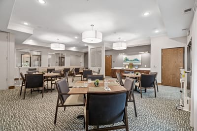 Dining area with tables and chairs in a clean interior space