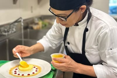 Chef plating a dessert in the facility kitchen
