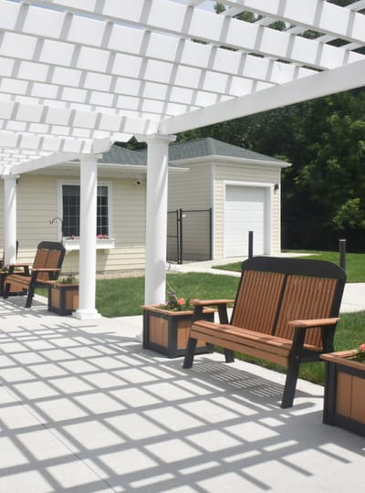 Outdoor seating area with shaded benches and planters