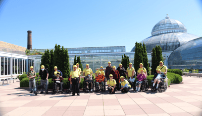 Residents enjoying an outing in outdoor space with caregivers
