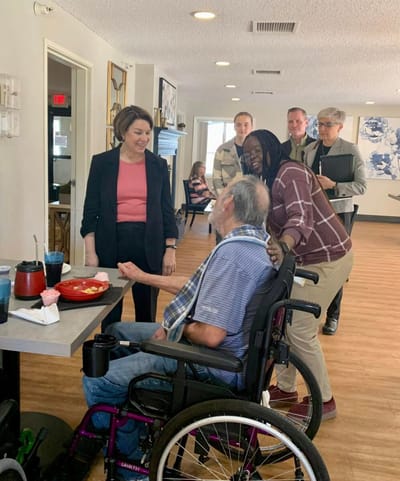 Residents interacting in a lively dining area