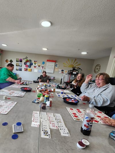 Residents enjoying a card game in a common area