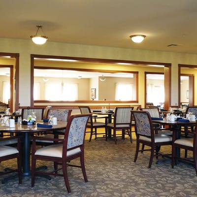 Dining room setup with tables and chairs