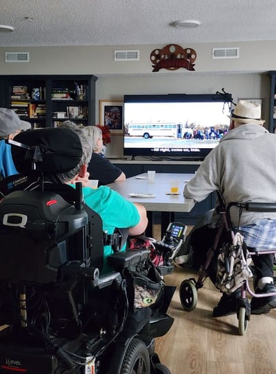 Residents watching a movie in a common area